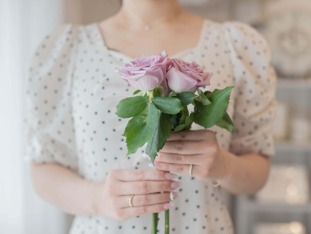 roseを持った水玉のワンピースの女性